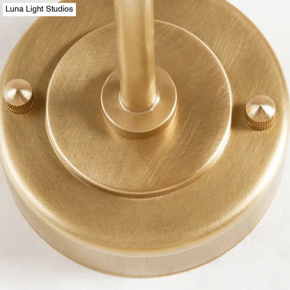 DecorBites™ DecorBites™ Contemporary Hand Blown Glass Wall Light with Brass Globe and Crossed Arm