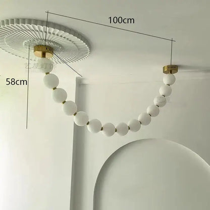 A modern white spherical bead decorbites contemporary led pendant chandelier with gold frosted glass and fluted ceiling mount