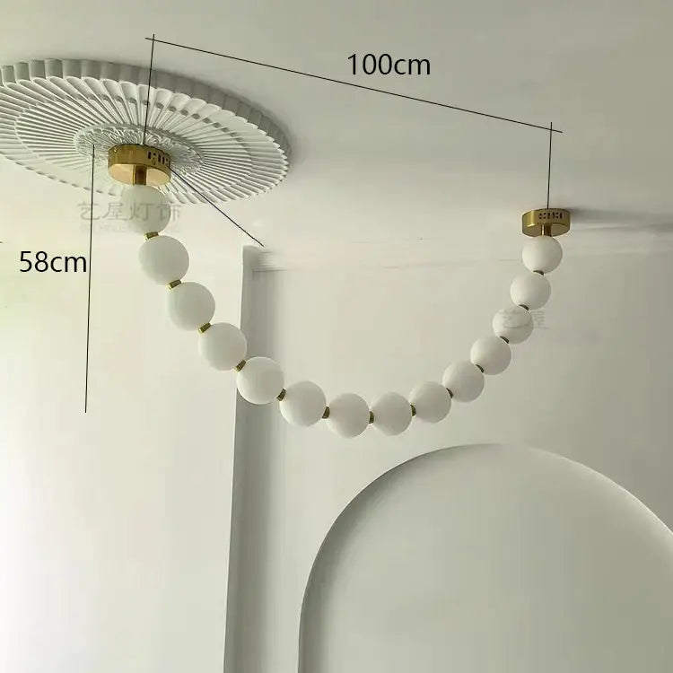 A modern white spherical bead decorbites contemporary led pendant chandelier with gold frosted glass and fluted ceiling mount