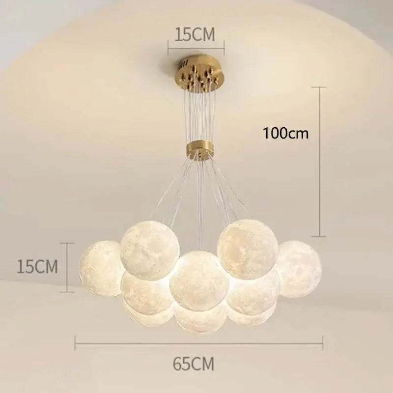 A modern brass-finished decorbites contemporary led pendant featuring illuminated gold moon spheres for dining room decor