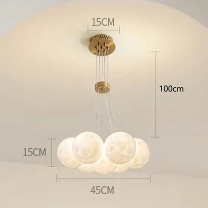 A decorbites contemporary led pendant light with five frosted moon-like bulbs and a brass finish for dining room decor