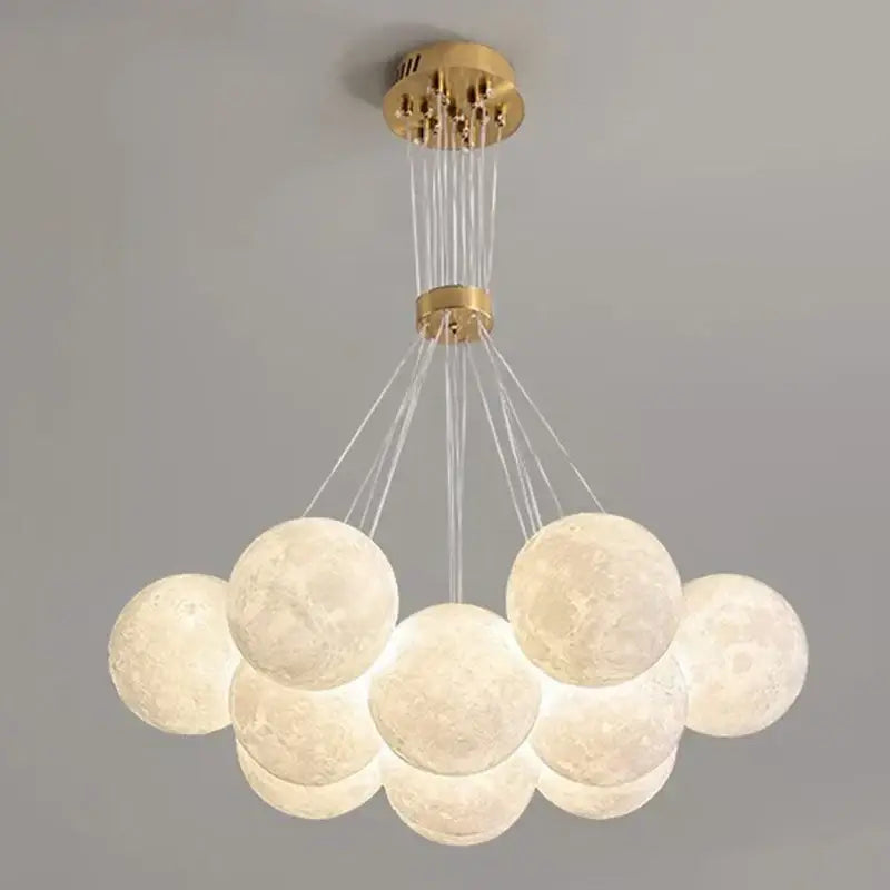 A gold modern ceiling chandelier with textured moon-like spherical pendant lights decorbites contemporary led decor