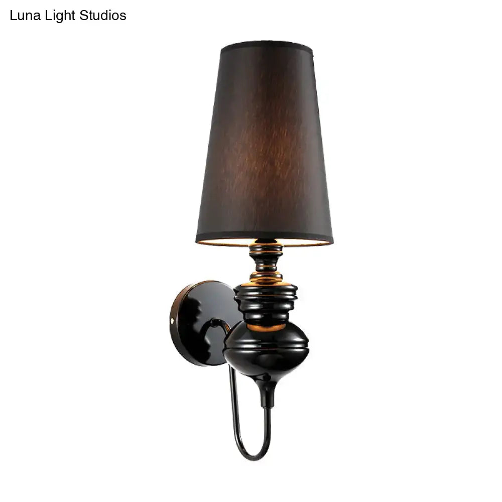 Contemporary matte black wall mount light with metal body and tapered black fabric shade for bedroom use