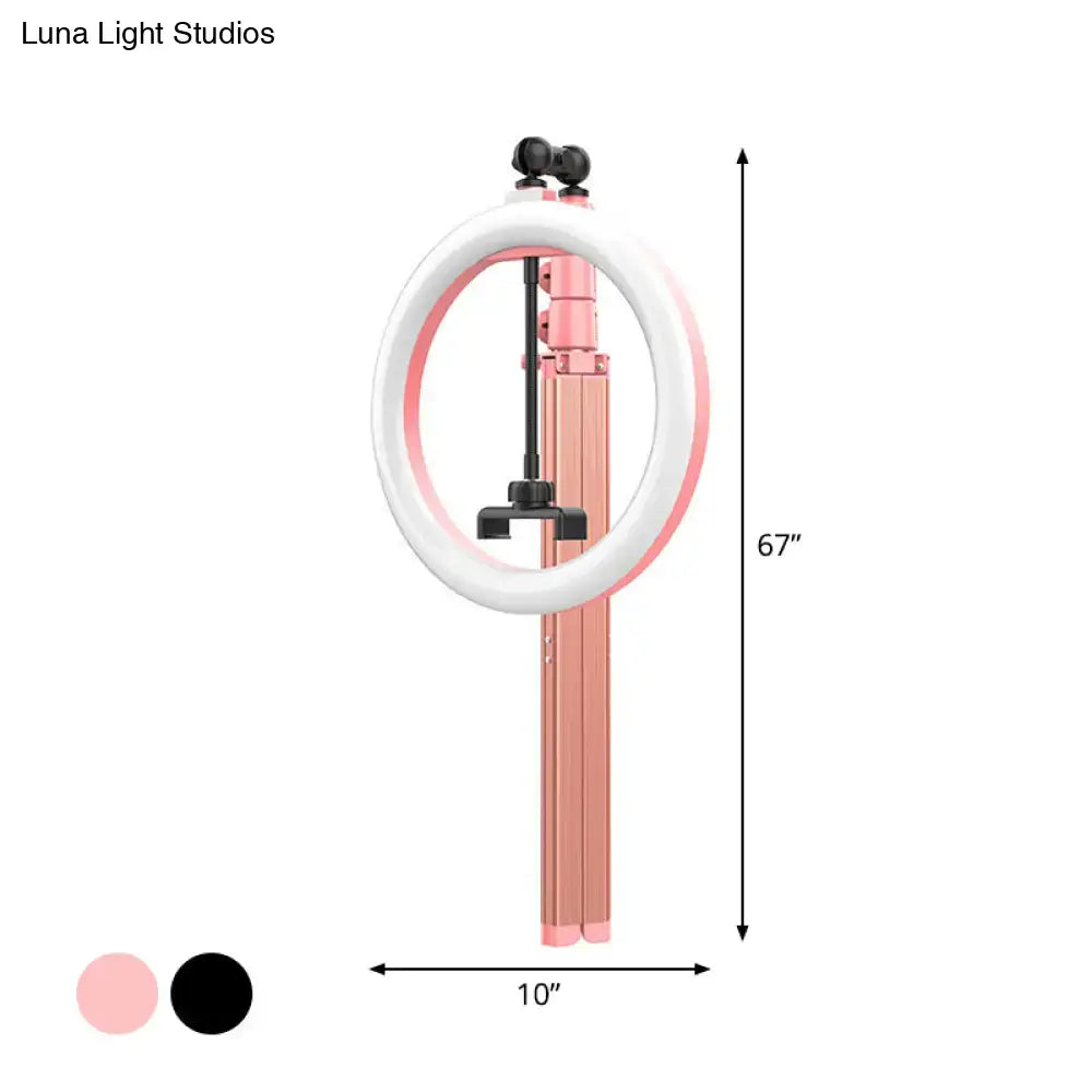 A 67-inch pink and white metallic circular mirror ring light with collapsible tripod stand and power source for bedrooms