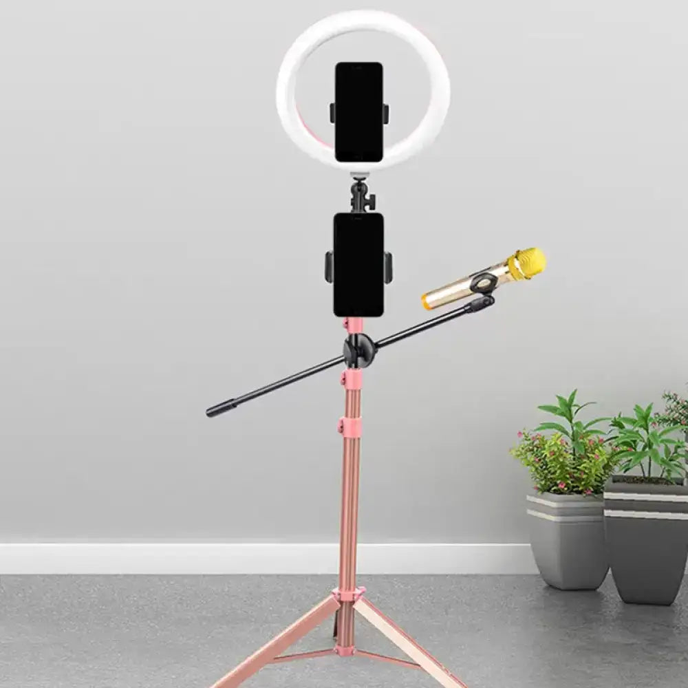Contemporary pink tripod stand with ring light and yellow microphone on adjustable arm for metallic circular mirror lamp power source