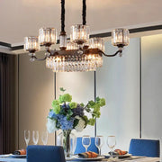A contemporary prismatic crystal hanging pendant with dark bronze frame and multiple crystal glass shades for restaurants