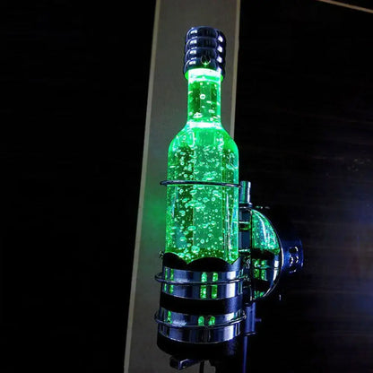 Contemporary purple crystal wall lamp featuring a glowing green liquid bottle with metallic cap in a chrome holder