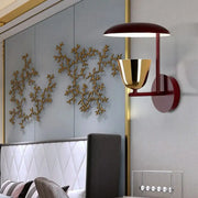 Contemporary red and gold wall-mounted light bedroom sconce with upward dome and downward bell-shaped fixtures