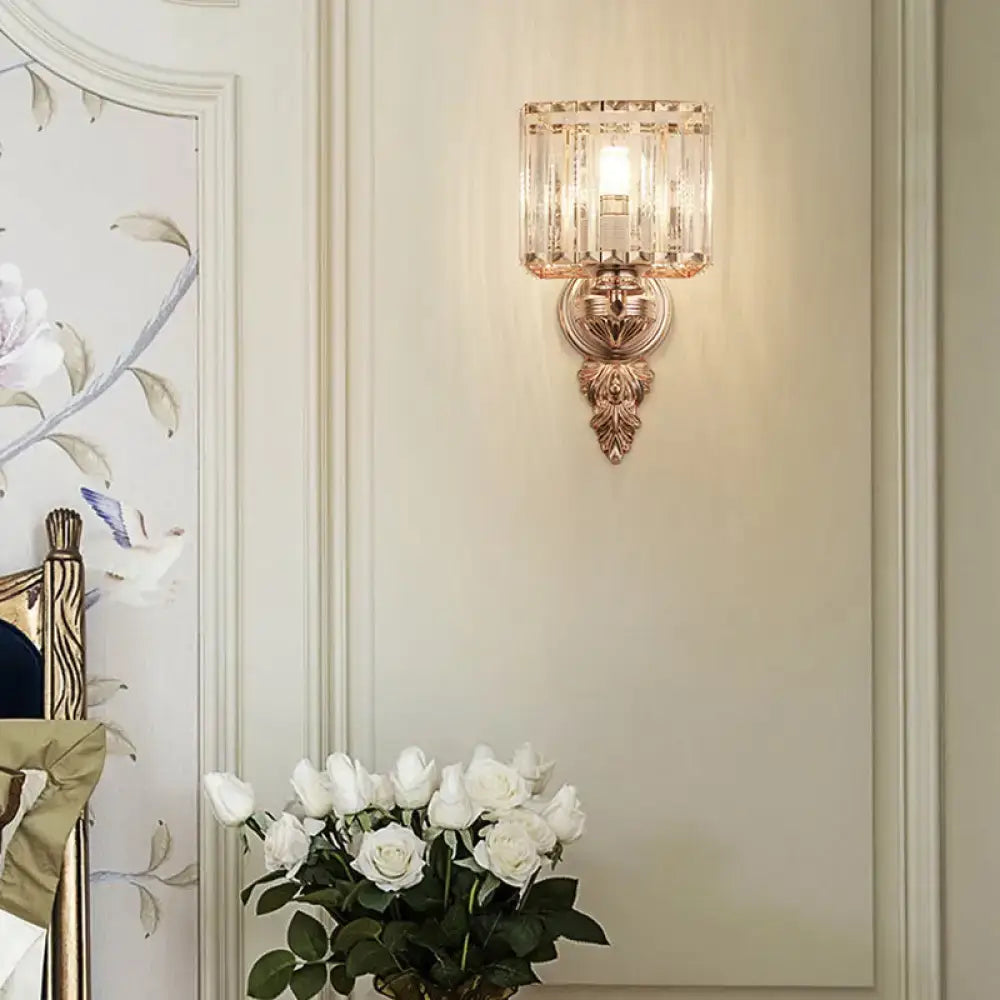 Contemporary rose gold wall sconce with rectangular clear crystal shade and ornate leaf-patterned base for e26 e27 bulbs