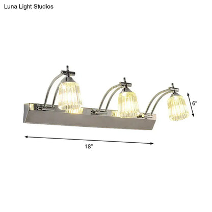 Contemporary silver 3 head crystal vanity light with faceted glass shades emits warm white wall light illumination