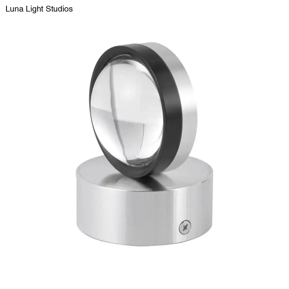 A sleek circular magnifying glass with black rim on a silver base complements a contemporary silver and black led wall lamp for dining room 110v-240v
