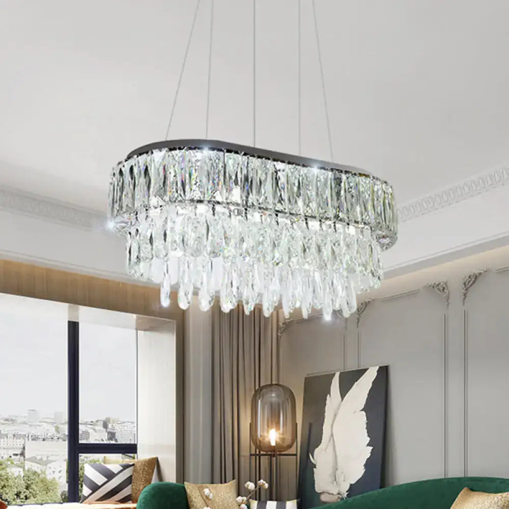 Contemporary silver oval crystal drip pendant light with sleek black frame and cascading clear faceted crystals for dining room