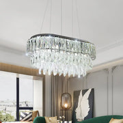Contemporary silver oval crystal drip pendant light with sleek black frame and cascading clear faceted crystals for dining room
