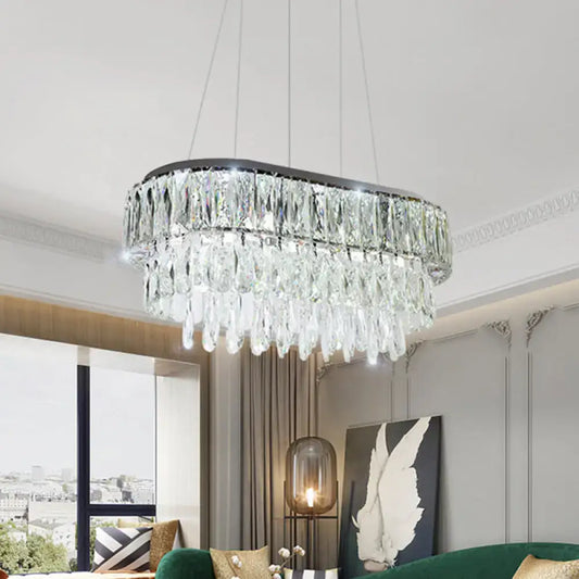 Contemporary silver oval crystal drip pendant light with sleek black frame and cascading clear faceted crystals for dining room