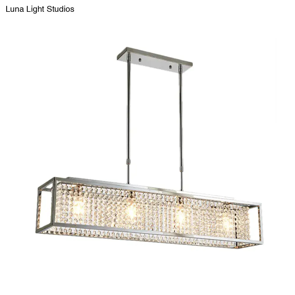 Contemporary silver rectangular chandelier with crystal drops featuring a sleek chrome frame and three illuminated bulbs