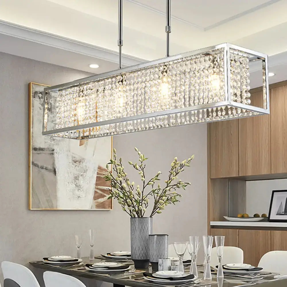 Contemporary silver rectangular chandelier featuring crystal drops and a sleek frame for dining room lighting