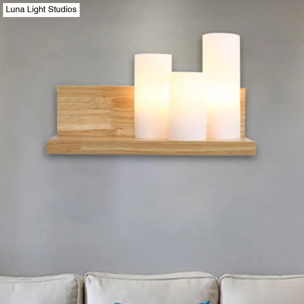 Contemporary tube shade wall lamp with three frosted bulbs on a minimalist wooden shelf for cloth shop 220v-240v