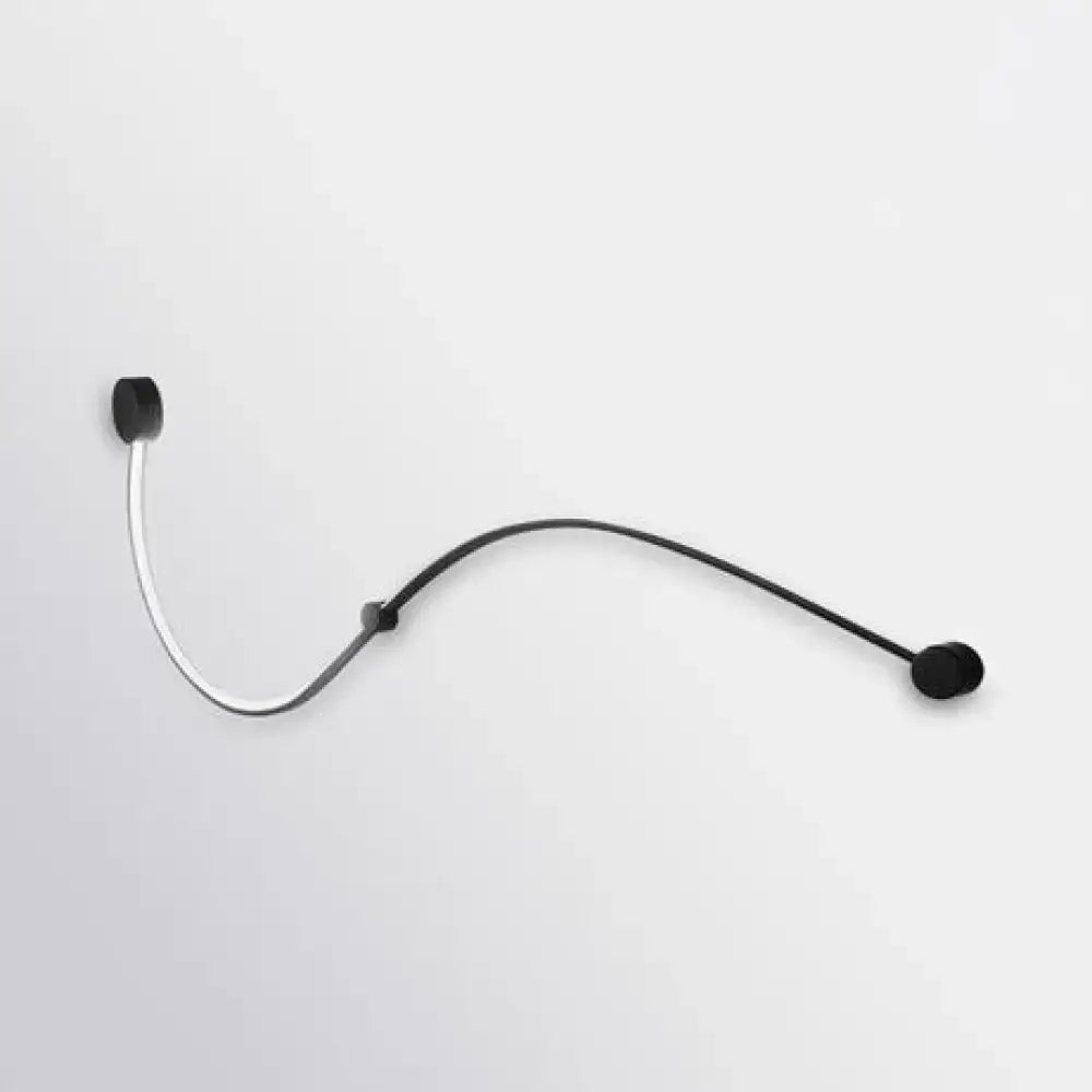 Contemporary twist black and white wall sconce with white warm light and a black and silver headset microphone with flexible gooseneck
