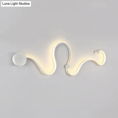 Contemporary twist wall sconce in white with sleek serpentine design and warm white light for bedroom ambiance
