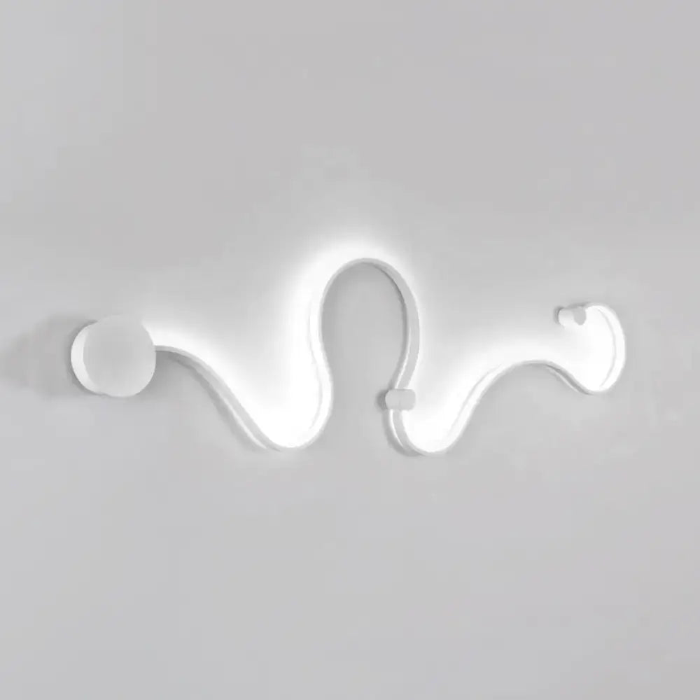 Contemporary twist wall sconce with a sleek white curved design providing warm white light for bedroom use