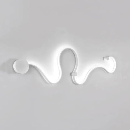 Contemporary twist wall sconce with a sleek white curved design providing warm white light for bedroom use