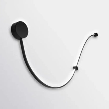 Black minimalist wall-mounted headphone stand with sleek curved design and contemporary twist wall sconce white warm light