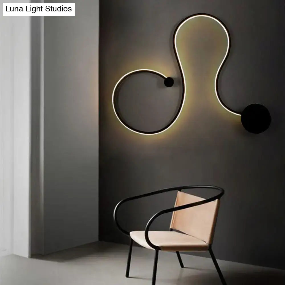 Contemporary twist black and white wall sconce with sleek curved led design and warm white light for bedroom use