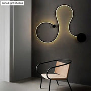 Contemporary twist black and white wall sconce with sleek curved led design and warm white light for bedroom use