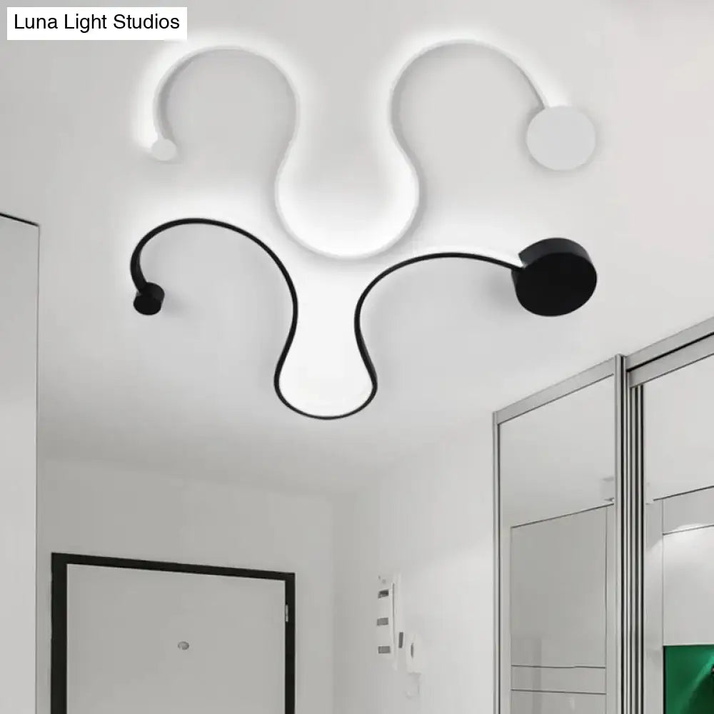 Contemporary twist black and white wall sconce with sleek curved arms and circular lamp heads for white warm bedroom light