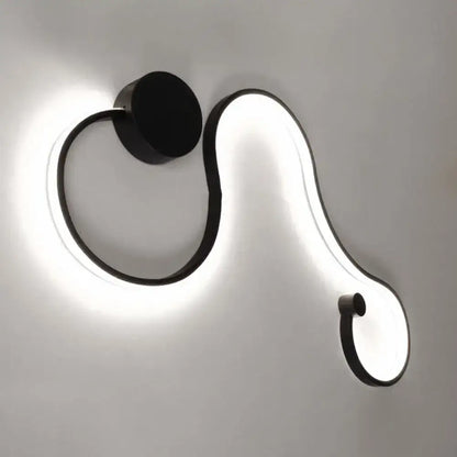 Contemporary twist black and white wall sconce with sleek curved design and warm white led light for bedroom use
