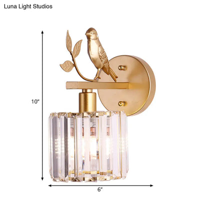 Aplique de pared contemporáneo DecorBites™ con cilindro de cristal K9, detalle de pájaro y acabado negro/dorado.