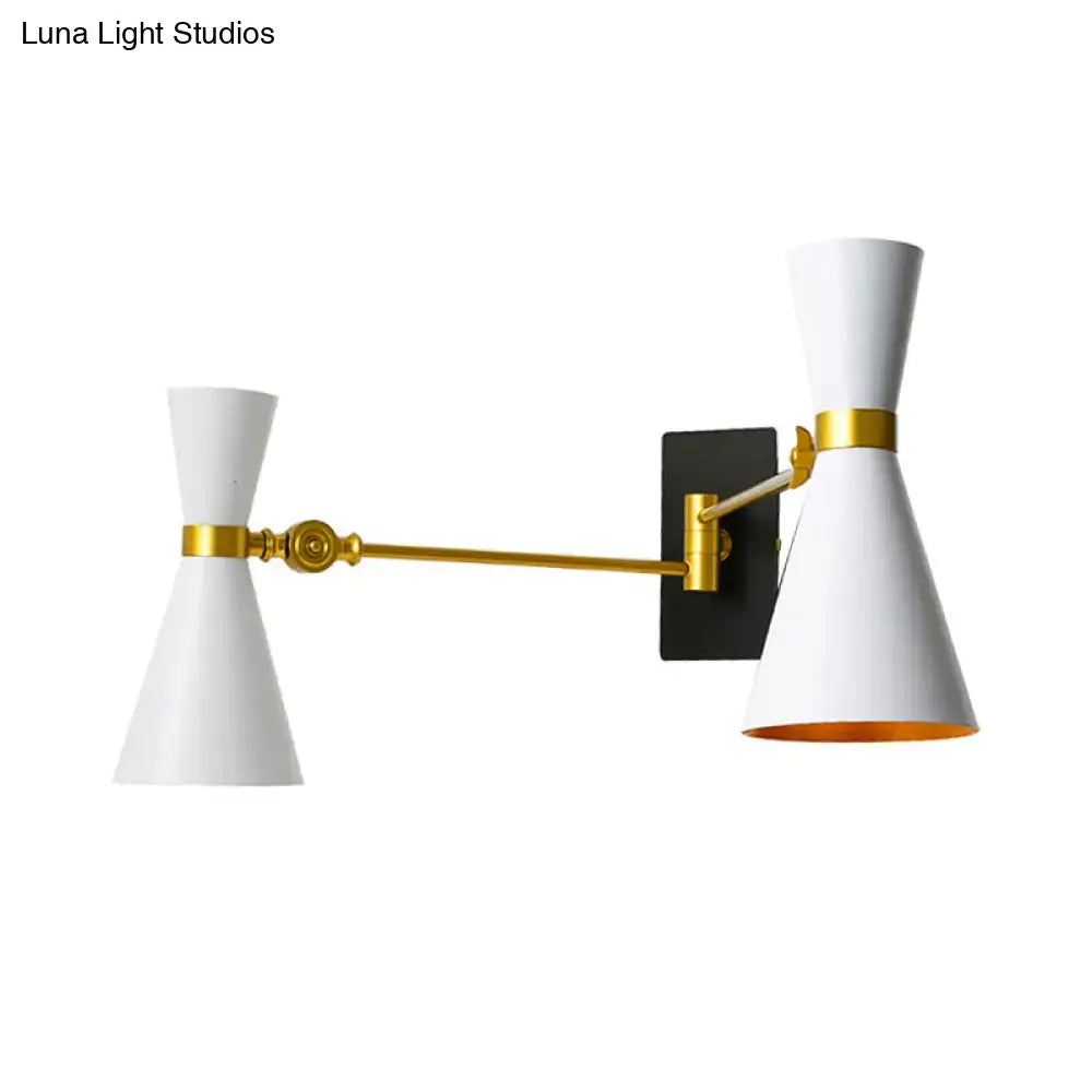 Contemporary white conical wall sconce with gold accents and black mounting plate featuring adjustable arm for bedroom lighting