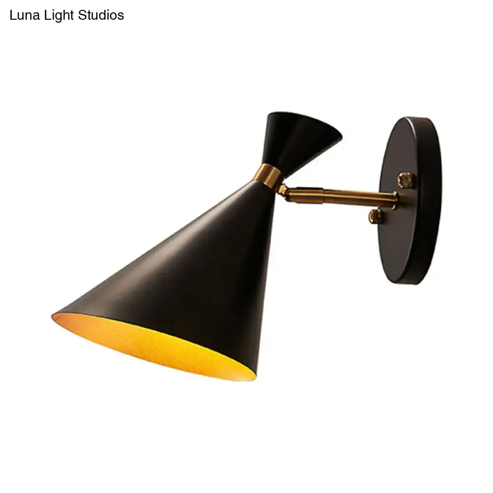 Black conical wall sconce with brass accent and gold-lined interior featuring adjustable arm for contemporary bedroom lighting