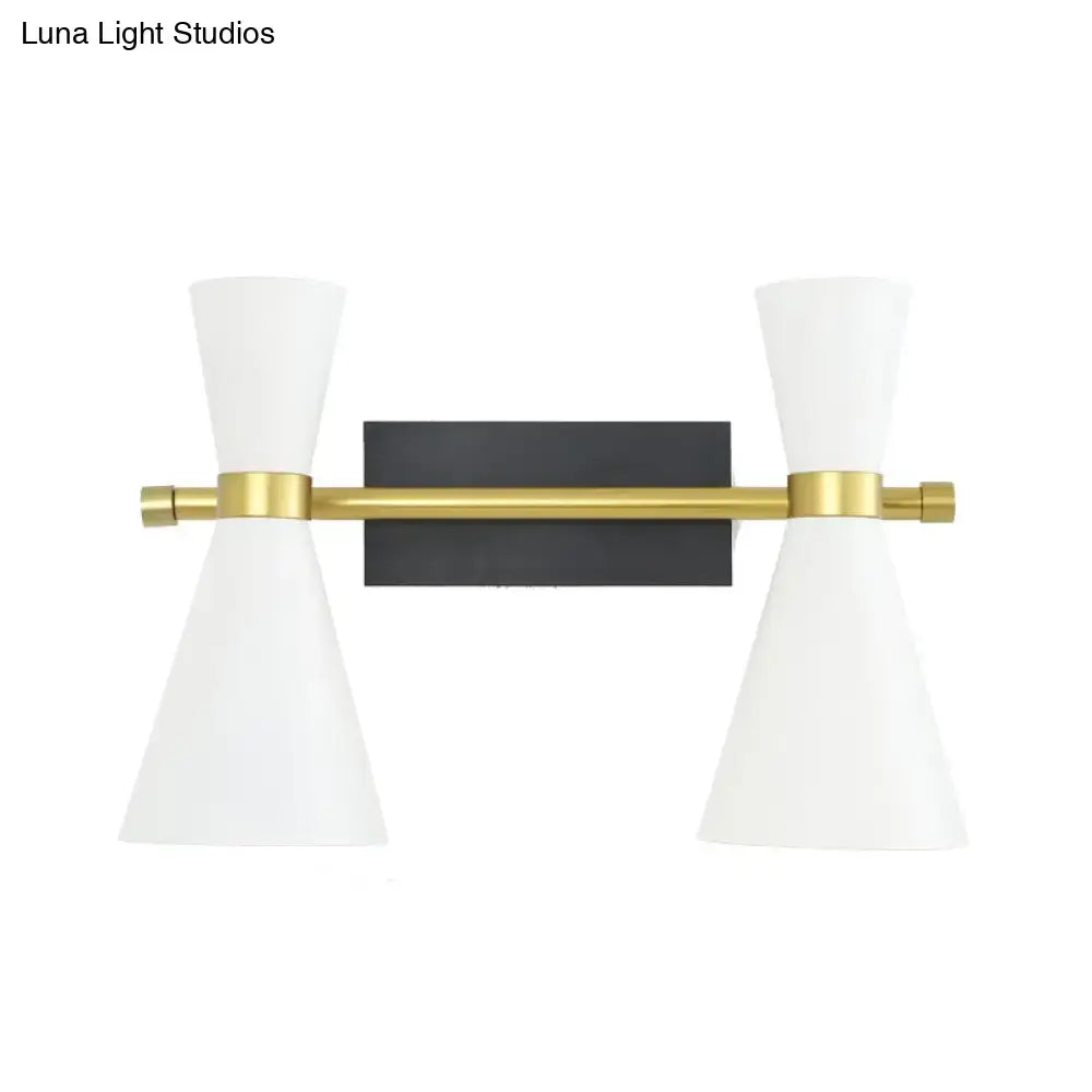 Modern two-light wall sconce with adjustable arm, white conical shades, brass bar, and black rectangular backplate