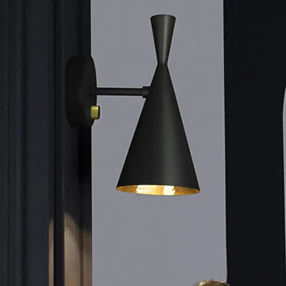 Contemporary black conical wall sconce with gold-lined interior and adjustable arm for bedroom lighting