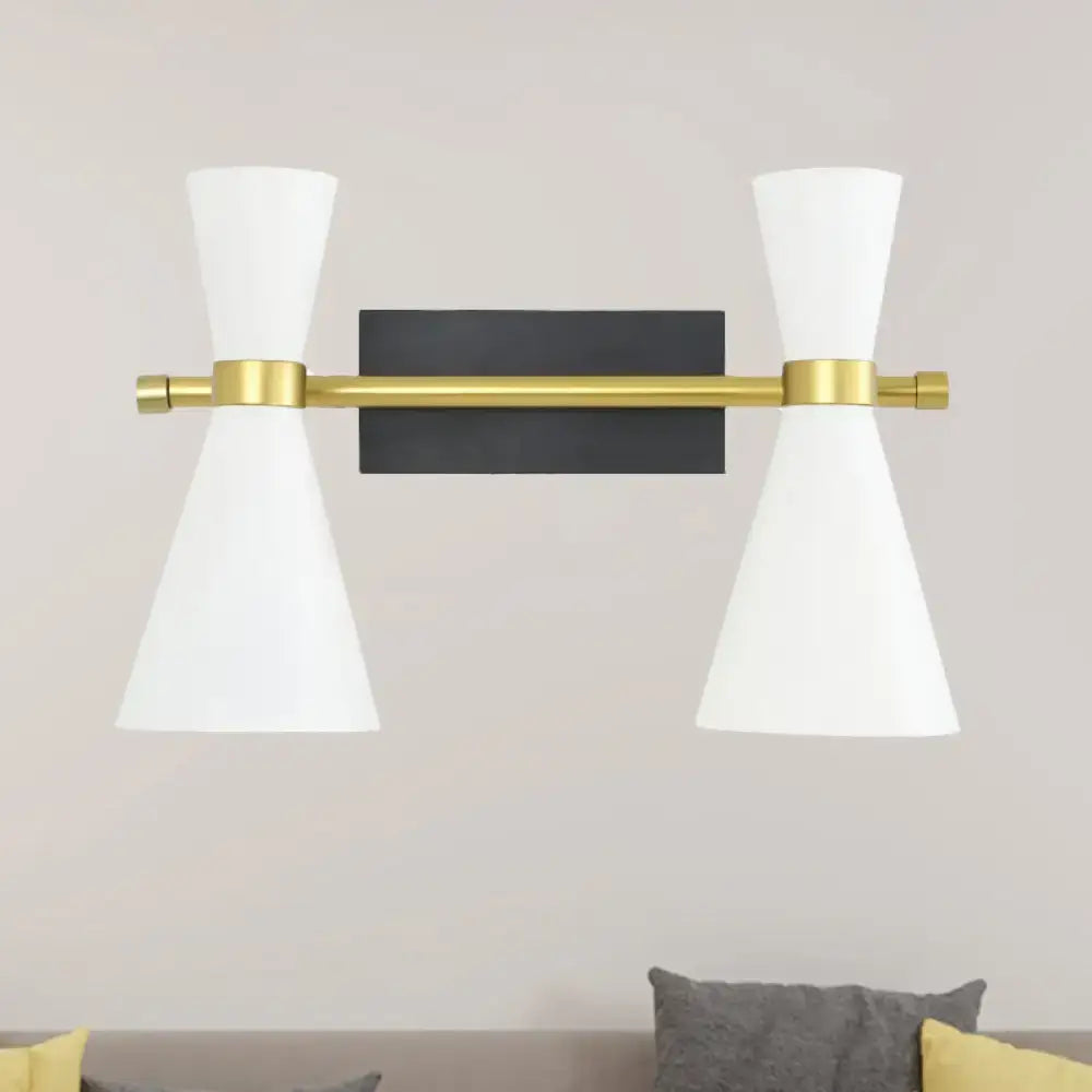 Contemporary wall sconce with adjustable arm featuring a sleek brass bar, black backplate, and white conical shades
