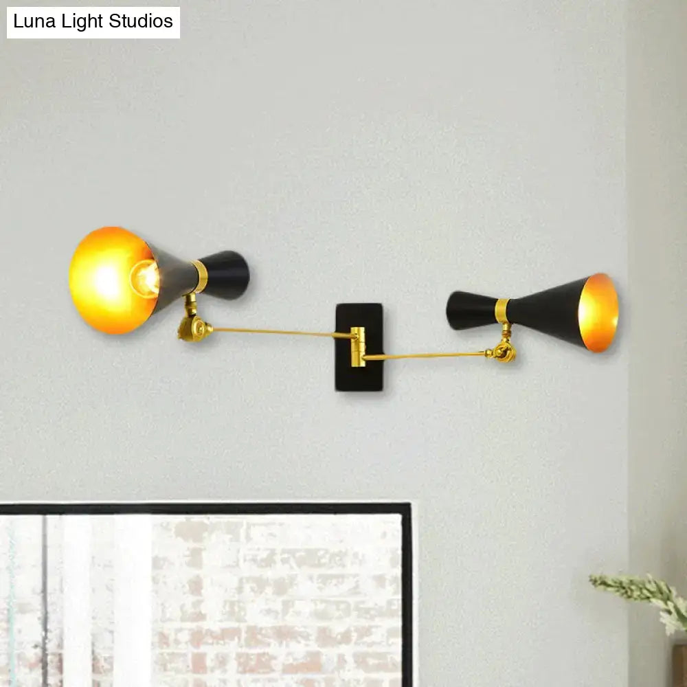 Black and gold wall sconce with adjustable arm and conical shades for contemporary bedroom lighting