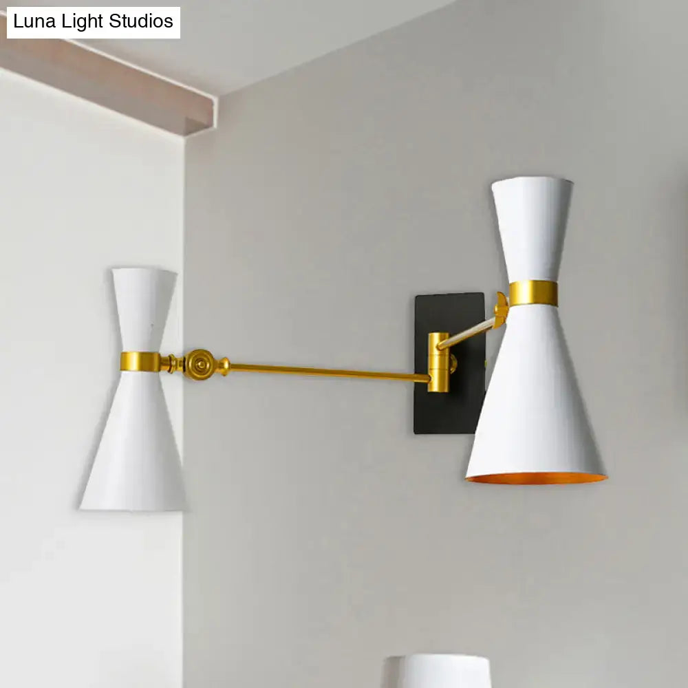 Contemporary white wall sconce with gold accents, adjustable arm, and black mounting plate for bedroom lighting