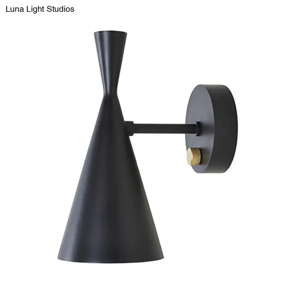 Black matte wall sconce with brass knob and adjustable arm ideal for contemporary bedroom lighting