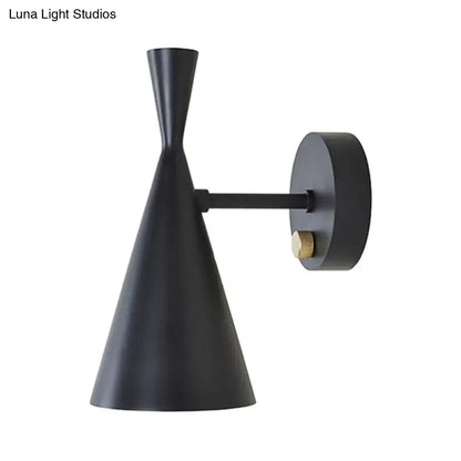 Black matte wall sconce with brass knob and adjustable arm ideal for contemporary bedroom lighting
