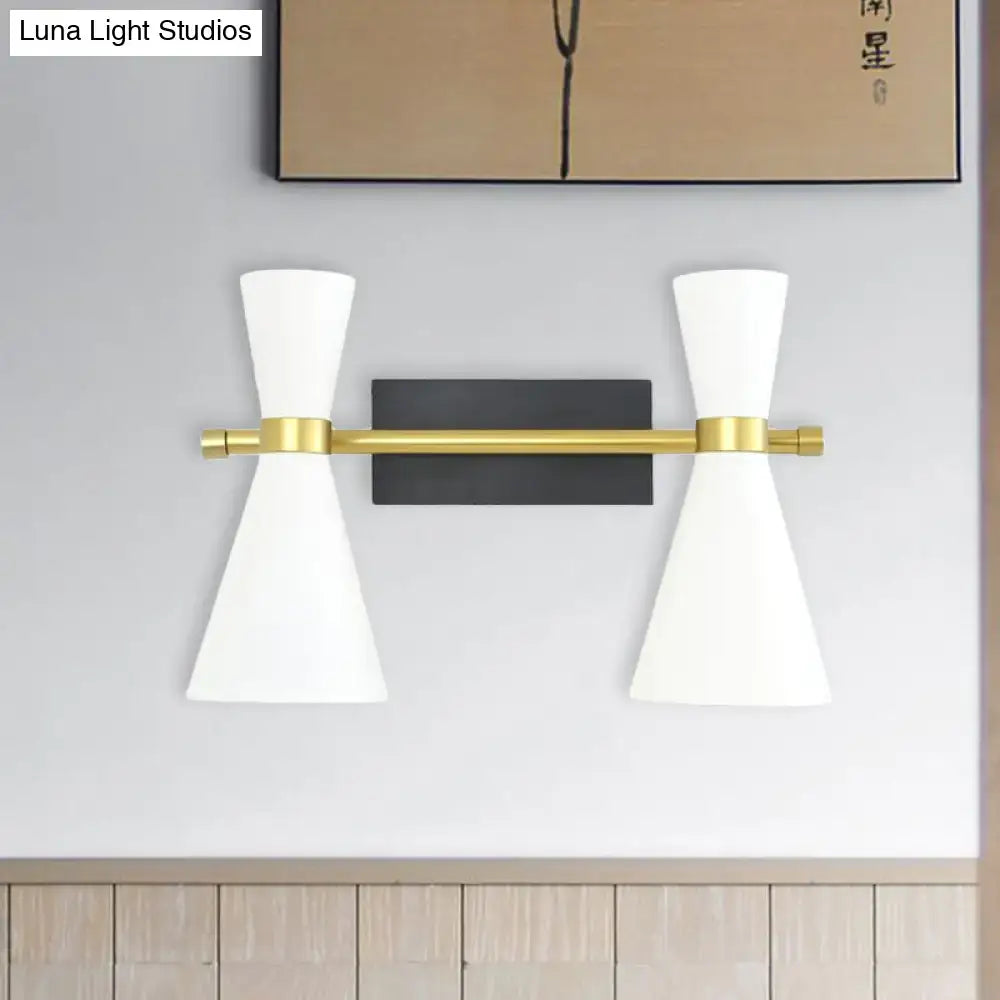 Contemporary white and gold wall sconce with adjustable arm, conical shades, black backplate, and polished brass accents