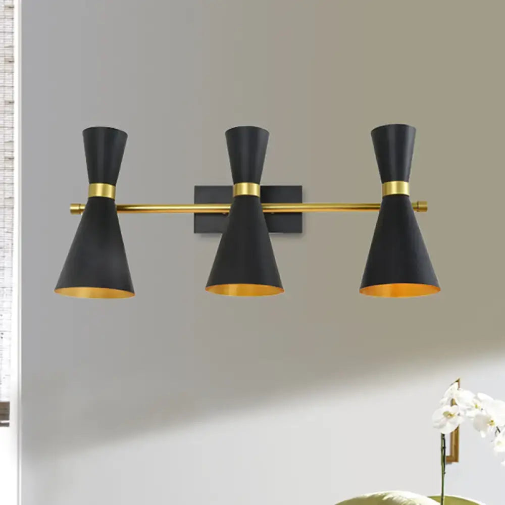 Contemporary black and gold three-light wall sconce with adjustable arm and conical shades for bedroom lighting