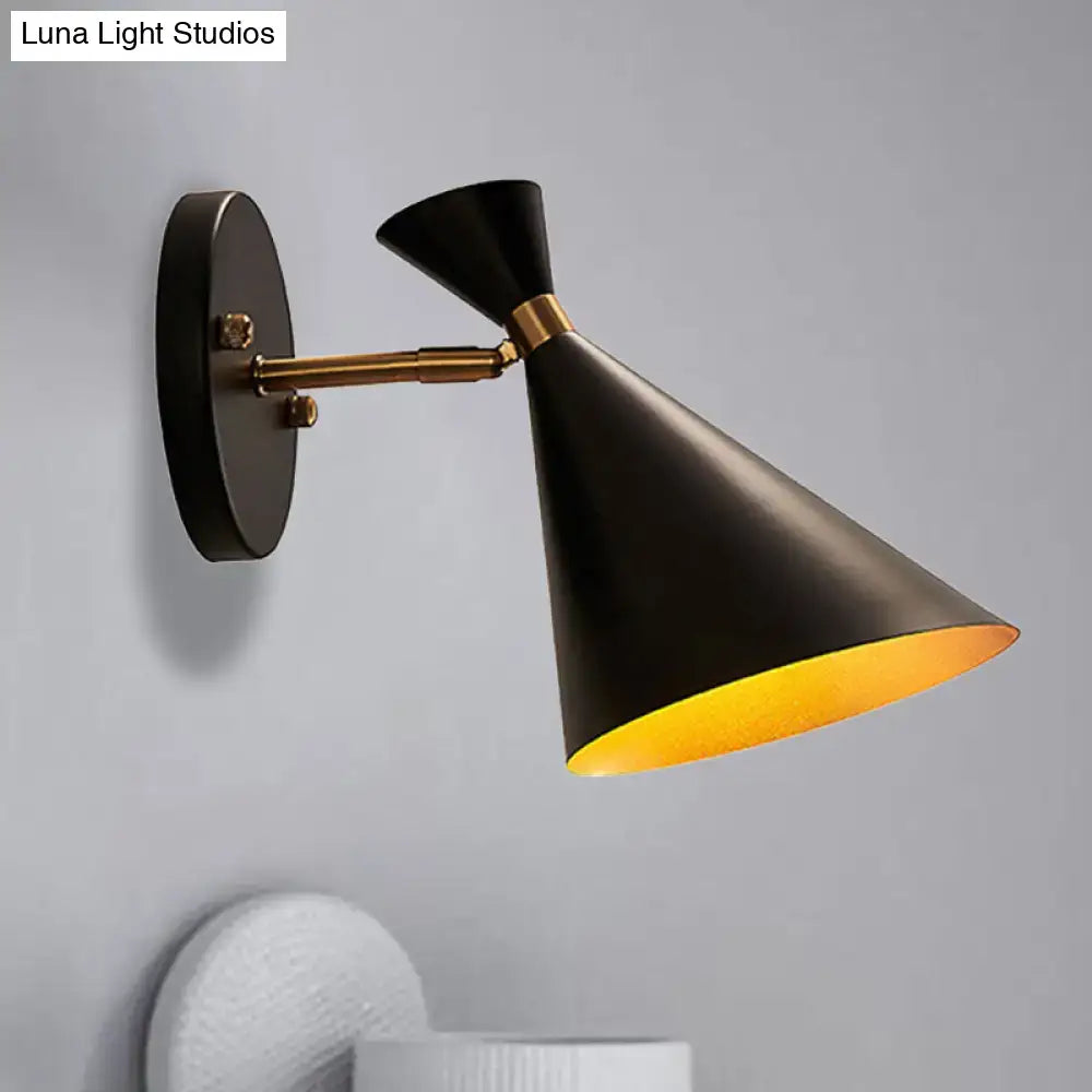 Black conical wall sconce with brass-finished adjustable arm and gold interior lining for contemporary bedroom lighting