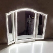 Contemporary white led three panel vanity mirror with 110v-120v led lights along the frame for bedroom use