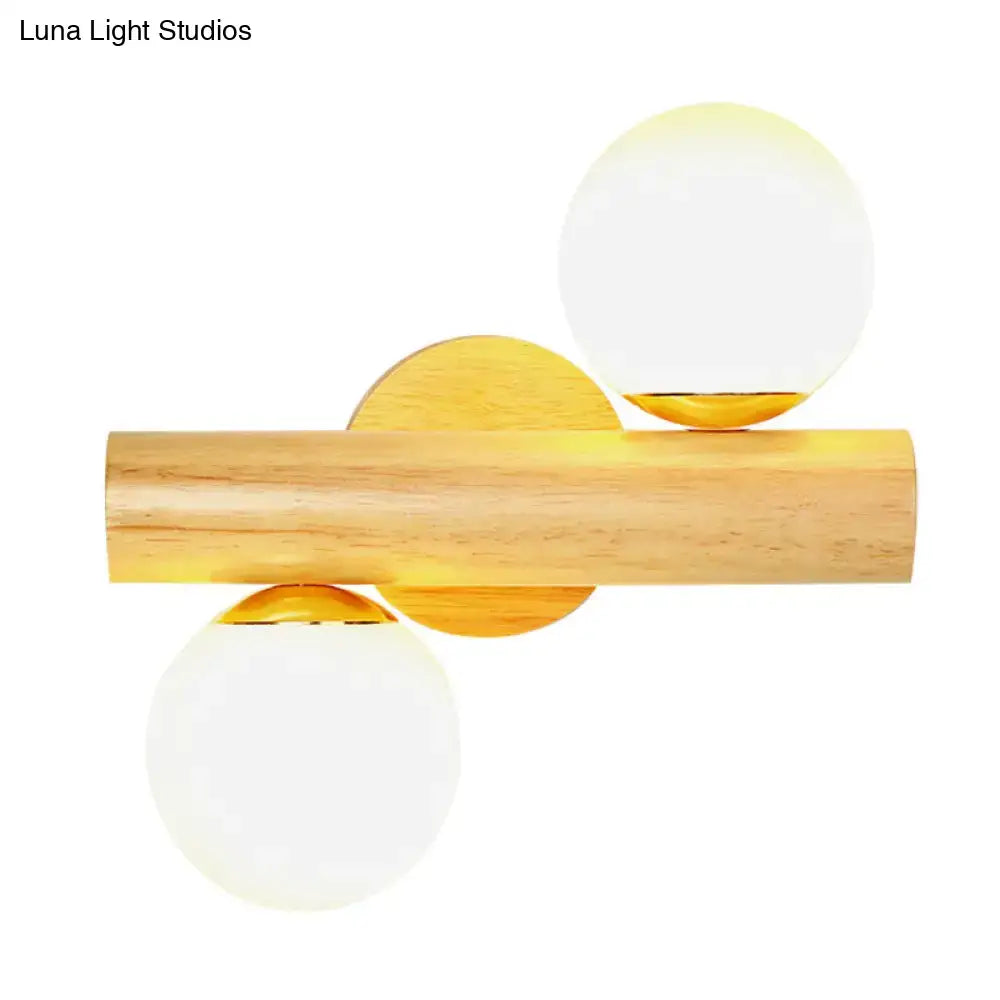 Contemporary white milk glass wall lamp with wooden base featuring natural wood cylinder and gold-toned accents