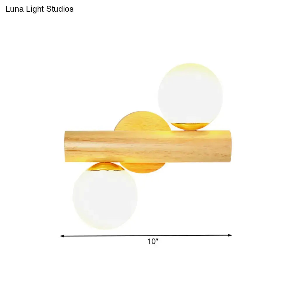 Contemporary white milk glass wall lamp with wooden base featuring frosted globe shades and gold accents for bathroom
