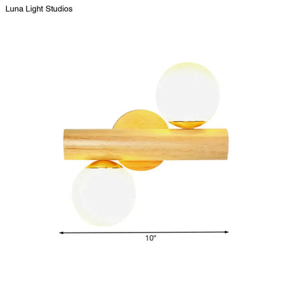 Contemporary white milk glass wall lamp with wooden base featuring frosted globe shades and gold accents for bathroom