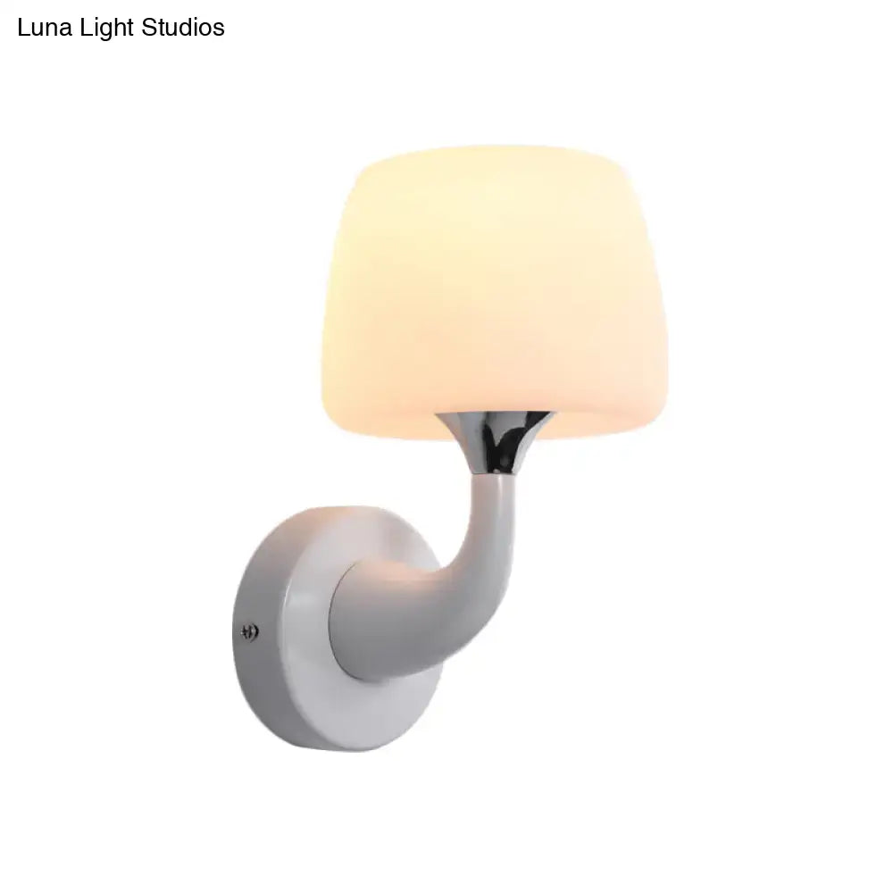 Contemporary wall light with a frosted white opal glass shade and chrome-finished metal arm light fixture for bedroom