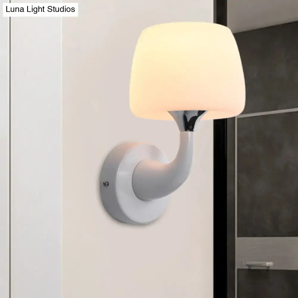 Contemporary white opal glass wall light with a sleek curved arm wall-mounted light fixture for bedroom use