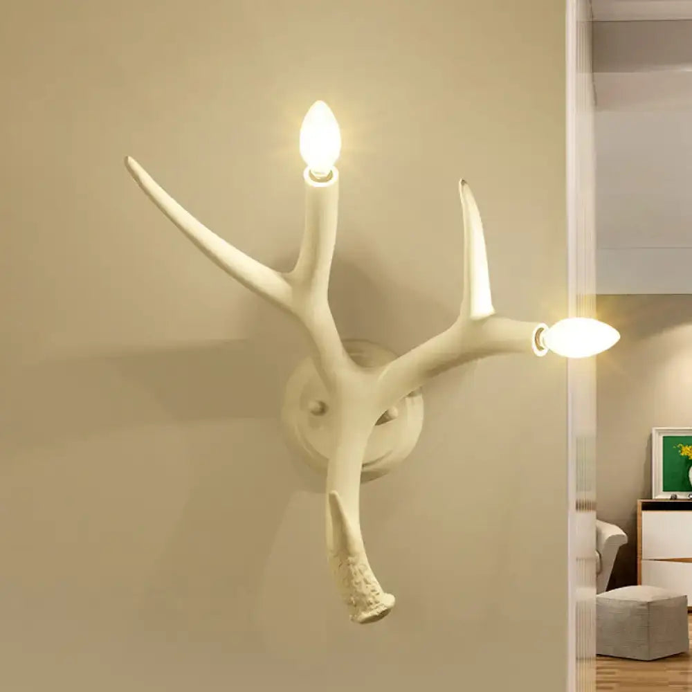 Contemporary white resin antler shaped wall sconce with two illuminated bulbs designed for dining rooms and restaurants